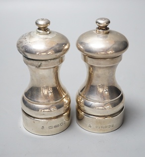 A modern pair of silver mounted salt and pepper mills, 10.4cm.